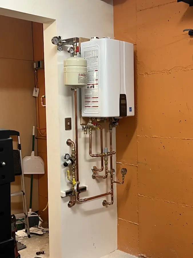 Plumbing technician inspecting water heater connections in Dalhart